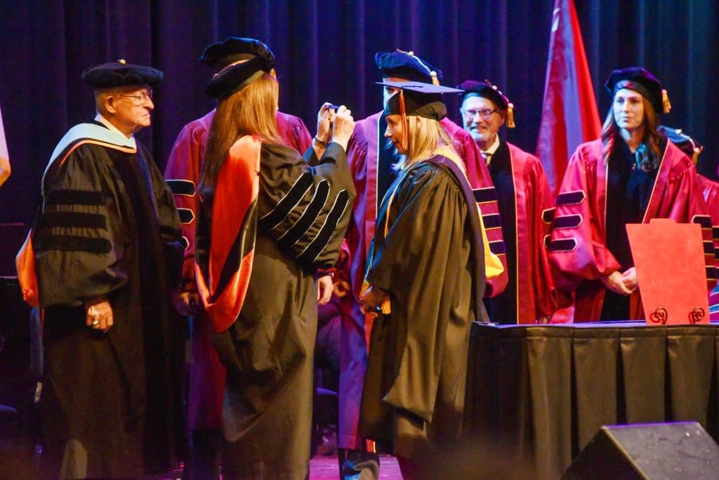 Diana Morris Watkins (right) receives the NOC Presidential Medallion from NOC President Emeritus Dr. Cheryl Evans while NOC President Emeritus Dr. Joe Kinzer (left) and the board of regents look on at Watkins’ Presidential Investiture on Tuesday. (photo by Shiloh Martin/Northern Oklahoma College).
