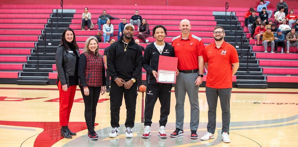 Xon Williams received the Jared Weiberg Endowed Memorial Scholarship at NOC’s game against Murray State Monday night.  Pictured (L-R):  NOC Vice President for Community Relations & Development Sheri Snyder; NOC President Diana Morris Watkins, William’s father Xon, Xon Williams, Ryan Paul (representing the Weiberg family), and Mavs’ coach Brandon Gossett. (photo by Shiloh Martin/Northern Oklahoma College)