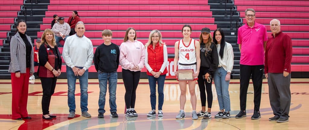 Alanna Williams was named the recipient of the Leo Canaday Memorial Scholarship Tuesday night before the NOC Lady Mavs hosted NOC Enid. Pictured (L-R):  Vice President for Development & Community Relations Sheri Snyder, Director of Development and Donor Relations Candy Oller, Alan Hardesty, Leo Hardesty, Mikaela Hardesty, Vicki Hardesty, Alanna Williams, Melissa Williams, Krislyn Williams, Lady Mavs Coach Greg Krause, Athletic Director Alan Foster.  (photo by Shiloh Martin/NOC)
