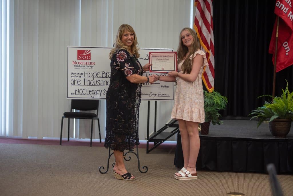 NOC Director of Development and Donor Relations Candy Oller presents the 2025 Legacy Scholarship to Hope Bradford (left) from Tonkawa High School.  (photo by Shiloh Martin/NOC).