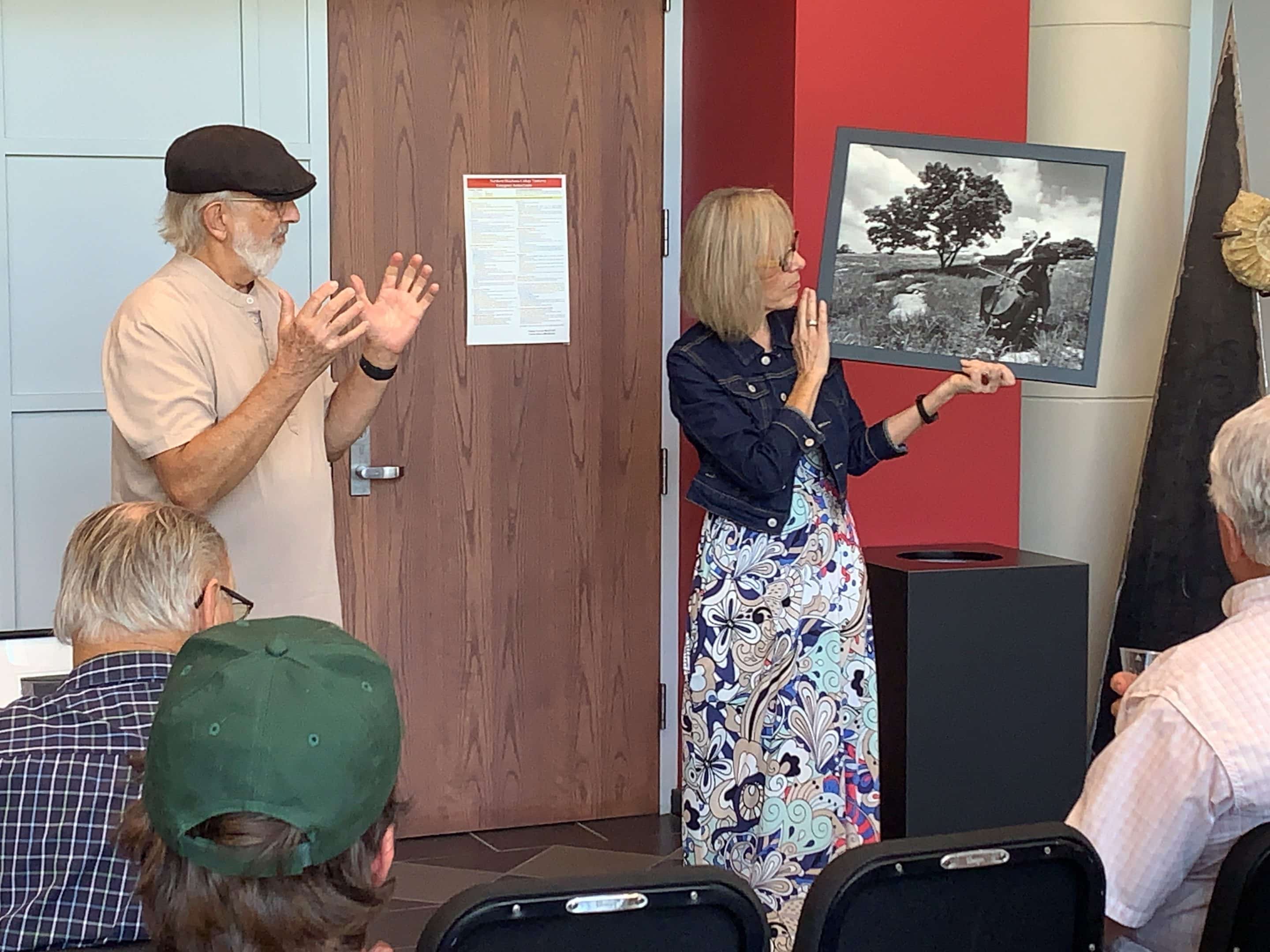 Tonkawa photographer Ken Crowder’s work is on exhibit at NOC Tonkawa’s Eleanor Hays Art Gallery through Dec. 12.  Crowder (left) explains some of his work, held by gallery director Audrey Schmitz.