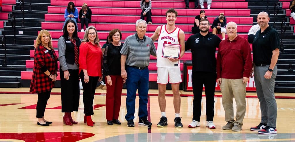 Northern Oklahoma College men’s basketball player Jaxton Bobik was awarded the Jared Weiberg Endowed Memorial Scholarship Monday night prior to the Mavericks’ game against Murray State. Bobik, a sophomore from Edmond, received the $1,000 scholarship honoring the legacy of former NOC Maverick Jared Weiberg. (photo by Caroline Hillock/NOC)
