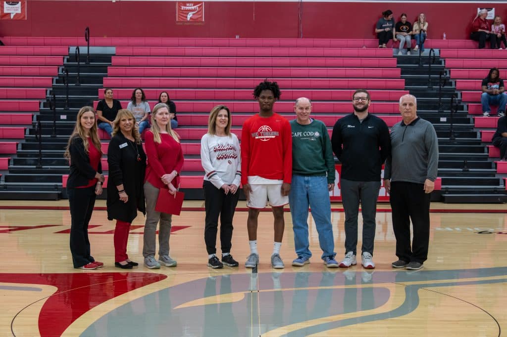 Northern Oklahoma College sophomore Boxy Wallace (center) received the Donald R. Hays Scholarship for the 2025-26 academic year last Thursday night. Joining him on the court are (L-R): Kayla Wooderson, Director of Development and Annual Giving; Candy Oller, Director of Development and Planned Giving; Larissa Hays Hautekeete, granddaughter of Eleanor and Donald R. Hays; Kay Abrahamsen; Boxy Wallace; Hans Abrahamsen; Brandon Gossett; and Alan Foster. (photo by Caroline Hillock/NOC)