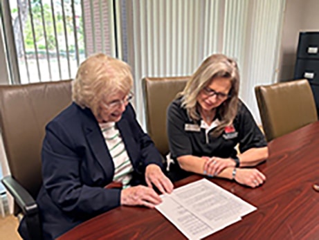Evelyn Coyle finalizes the Horticulture Student Scholarship agreement with NOC President Diana Morris. 